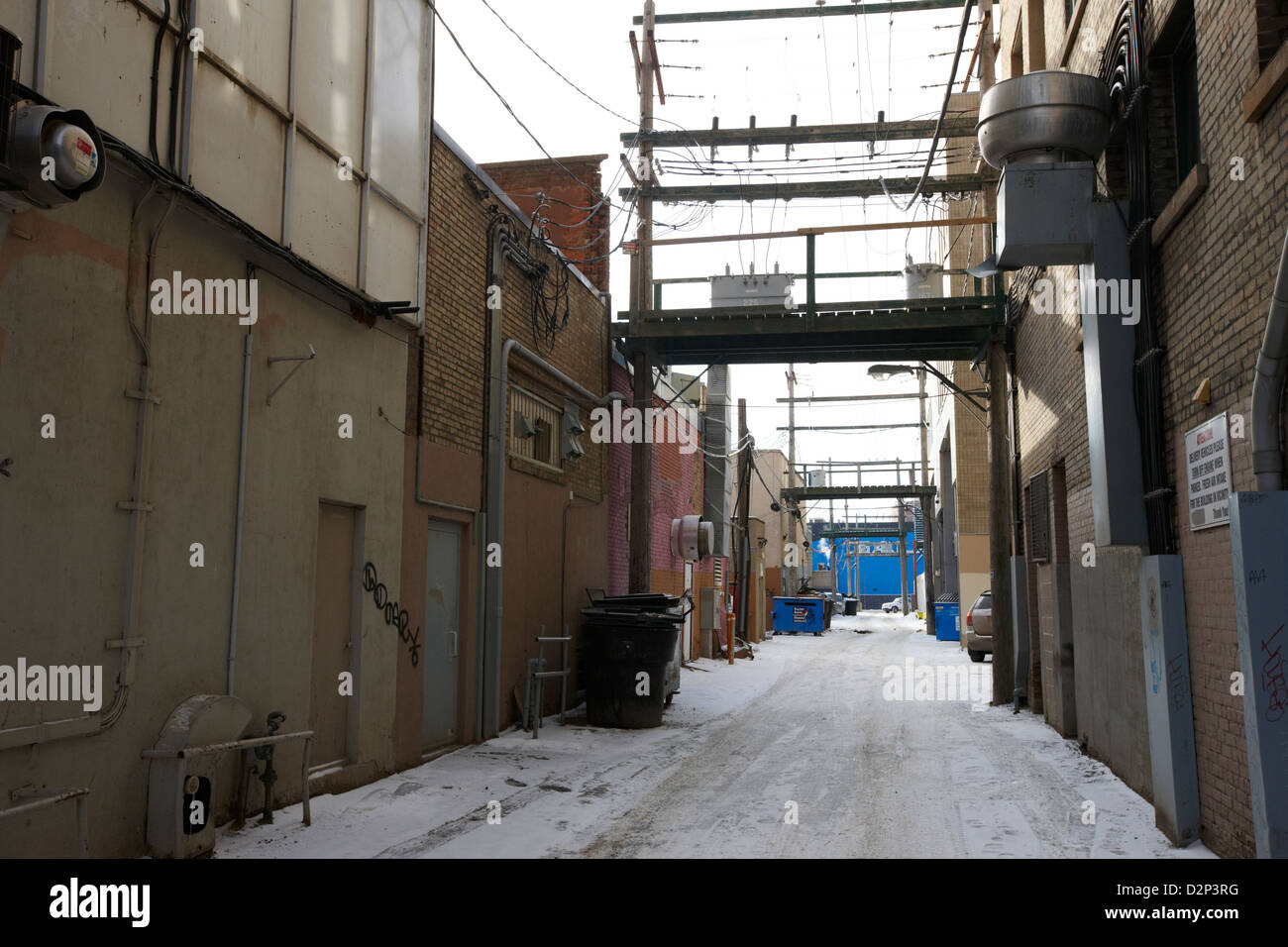 snow in an alleyway with electricity distribution in commerical area of downtown Saskatoon Saskatchewan Canada Stock Photo