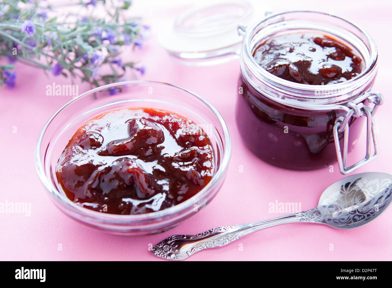 sweet plum jam in a transparent bowl, closeup Stock Photo