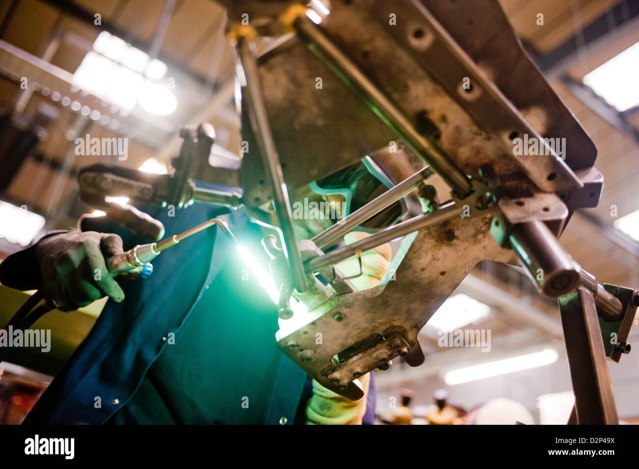 London, UK – 29 January 2013: a workman brazes components of a folding ...