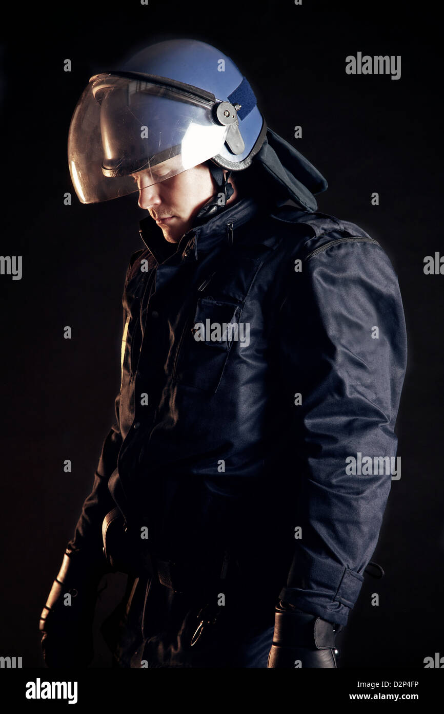 Police officer wearing protective uniform as protection from protesters Stock Photo