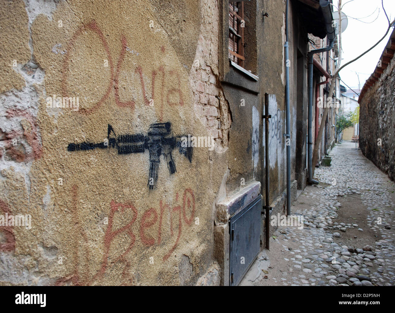 Gun graffiti on wall in Sarajevo alley. Stock Photo