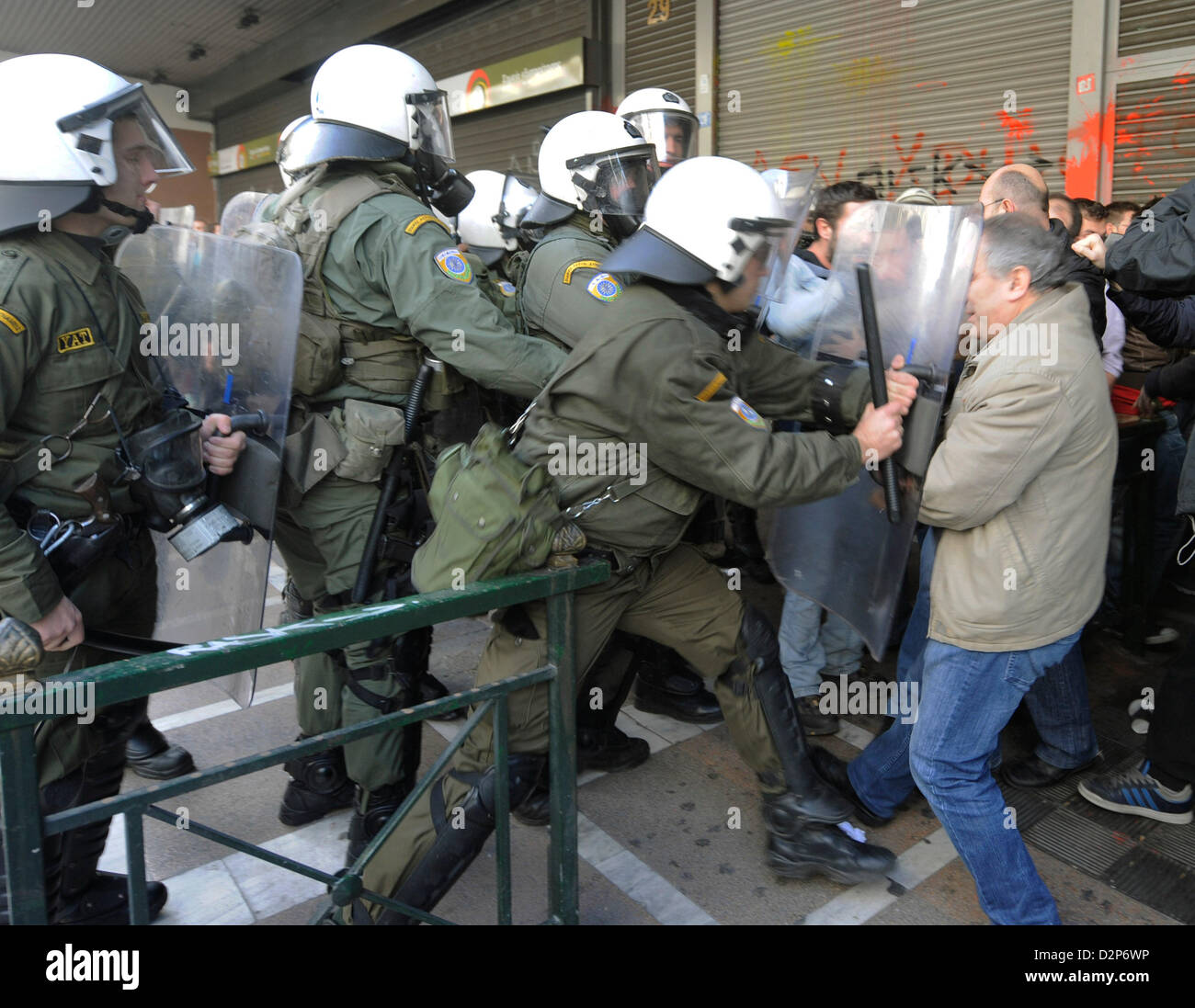 Athens, Greece. 30th January 2013. Clashes between police and union members in front of the Labour Ministry in Athens, Greece. In protest against further austerity measures, PAME union members have stormed the Ministry of Labour and occupied the office of the Labour Minister Yiannis Vroutsis. Photo: Giorgos Nikolaidis / Art of Focus/ Alamy Live News Stock Photo