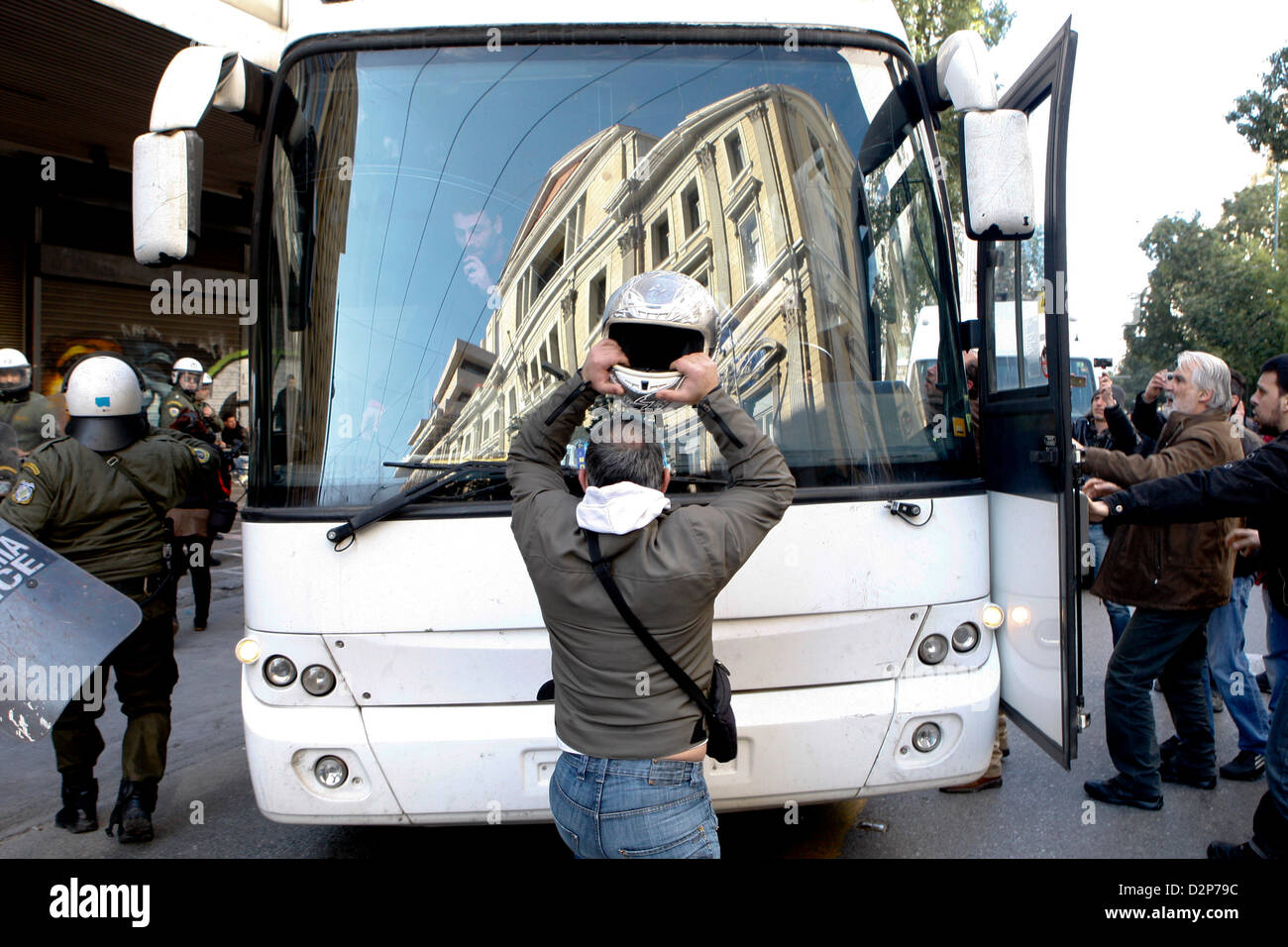 Athens, Greece. 30th January 2013. A man broke the bus window with his ...