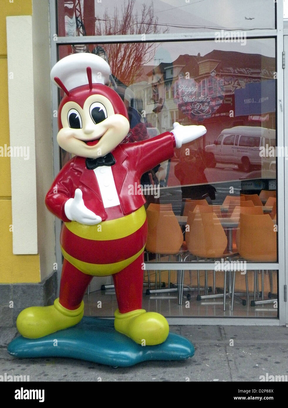 A statue outside of a bakery under the elevated subway tracks in Elmhurst, Queens, New York Stock Photo