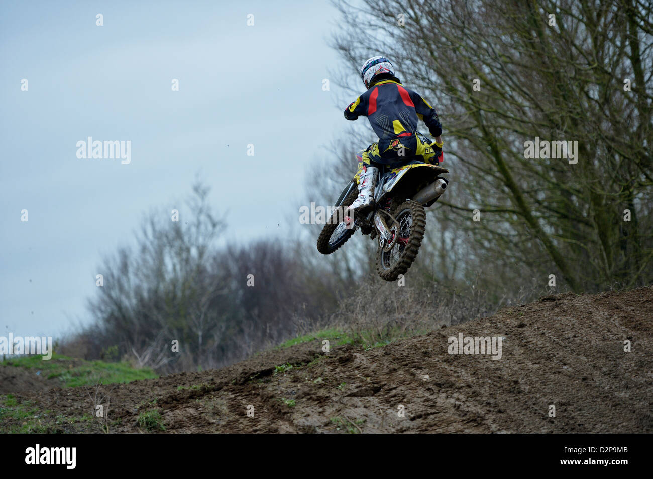 A motocross rider doing a (scrub) jump on a motocross built track Stock Photo
