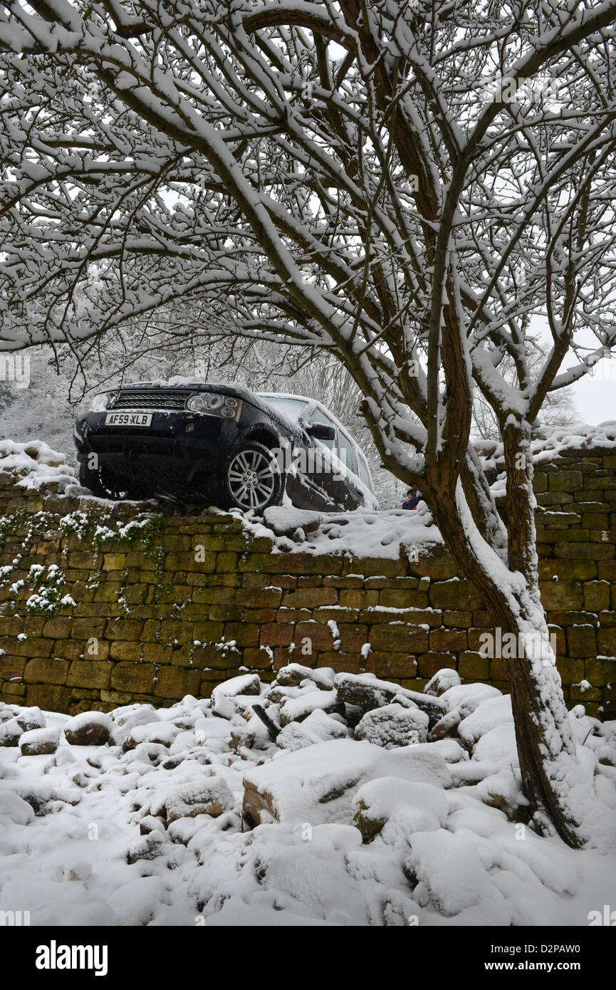 A Range Rover crashed through a wall after sliding in snowy conditions on a hill known locally are 'The Ladder' in Nailsworth ne Stock Photo