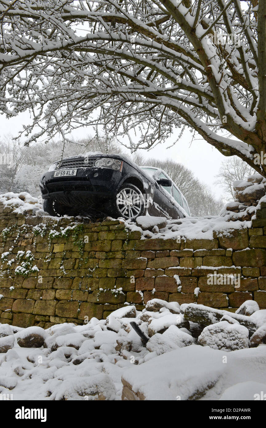 A Range Rover crashed through a wall after sliding in snowy conditions on a hill known locally are 'The Ladder' in Nailsworth ne Stock Photo