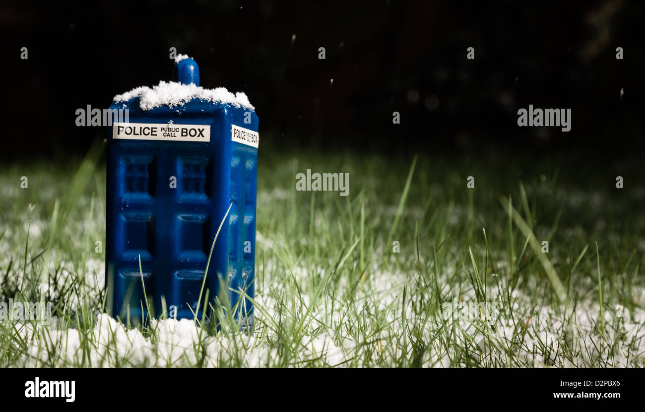 A police box or TARDIS from Doctor Who in the garden in the snow Stock Photo