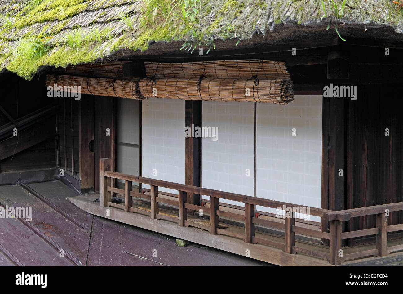 An old traditional wooden house with thatched roof in Mitake-san ...