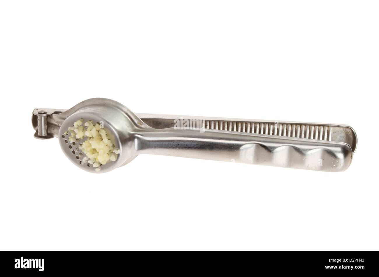 Garlic press with pressed garlic isolated against white Stock Photo