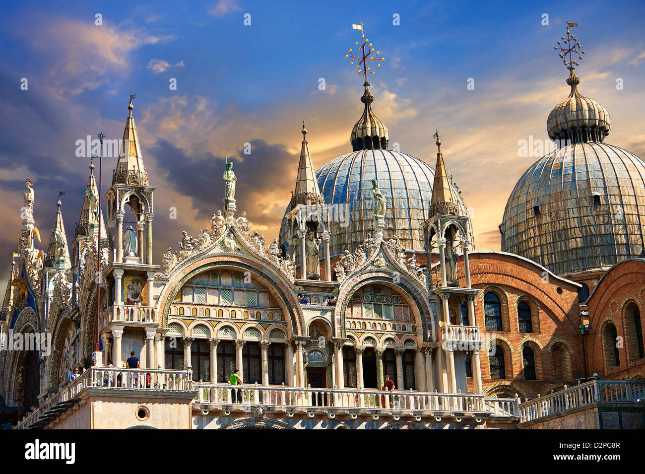 Facade with Gothic architecture and Romanesque domes of St Mark's Basilica at sunset , Venice Stock Photo