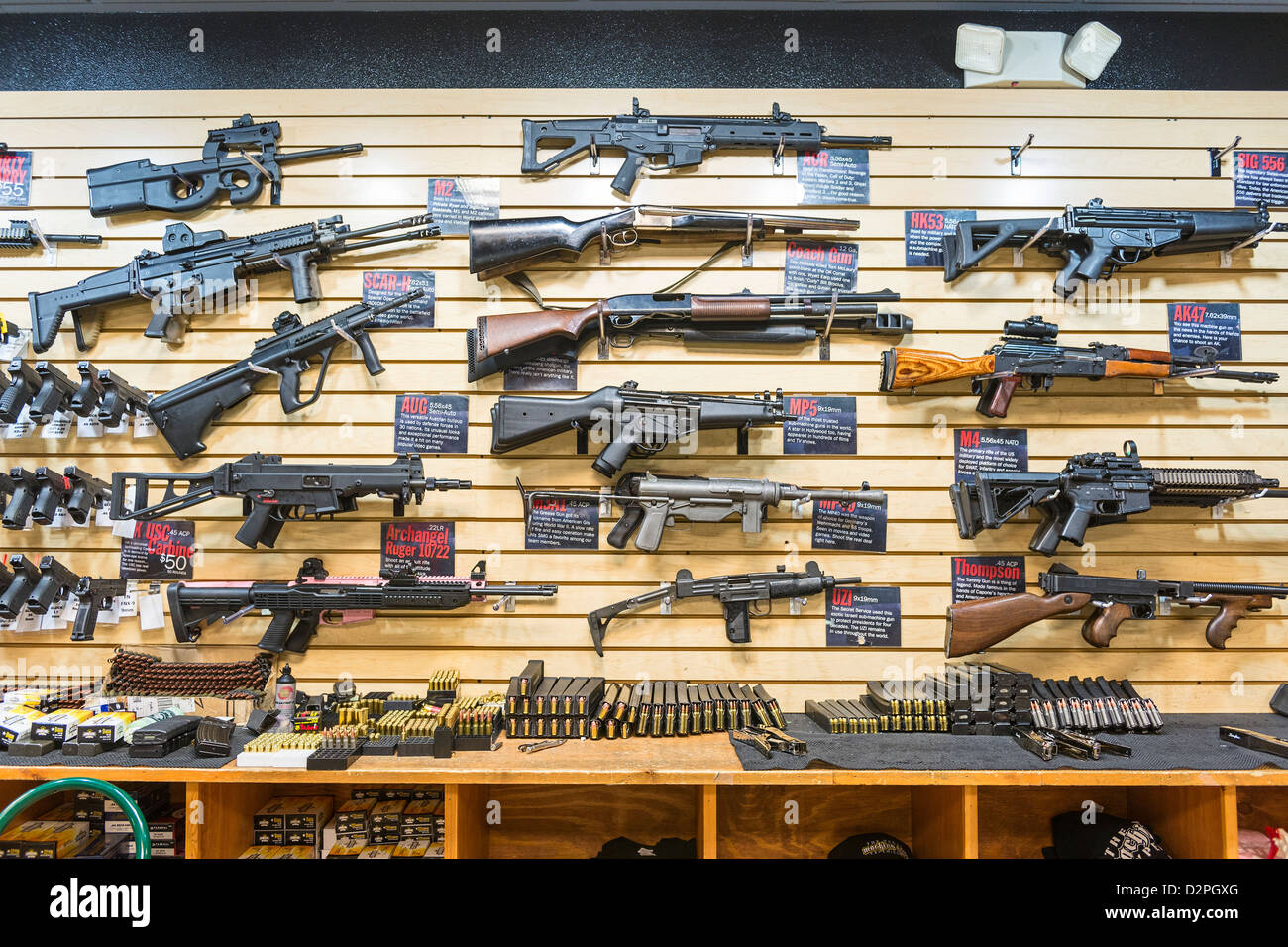 A large variety of guns, rifles, and weapons at a gun store. Stock Photo