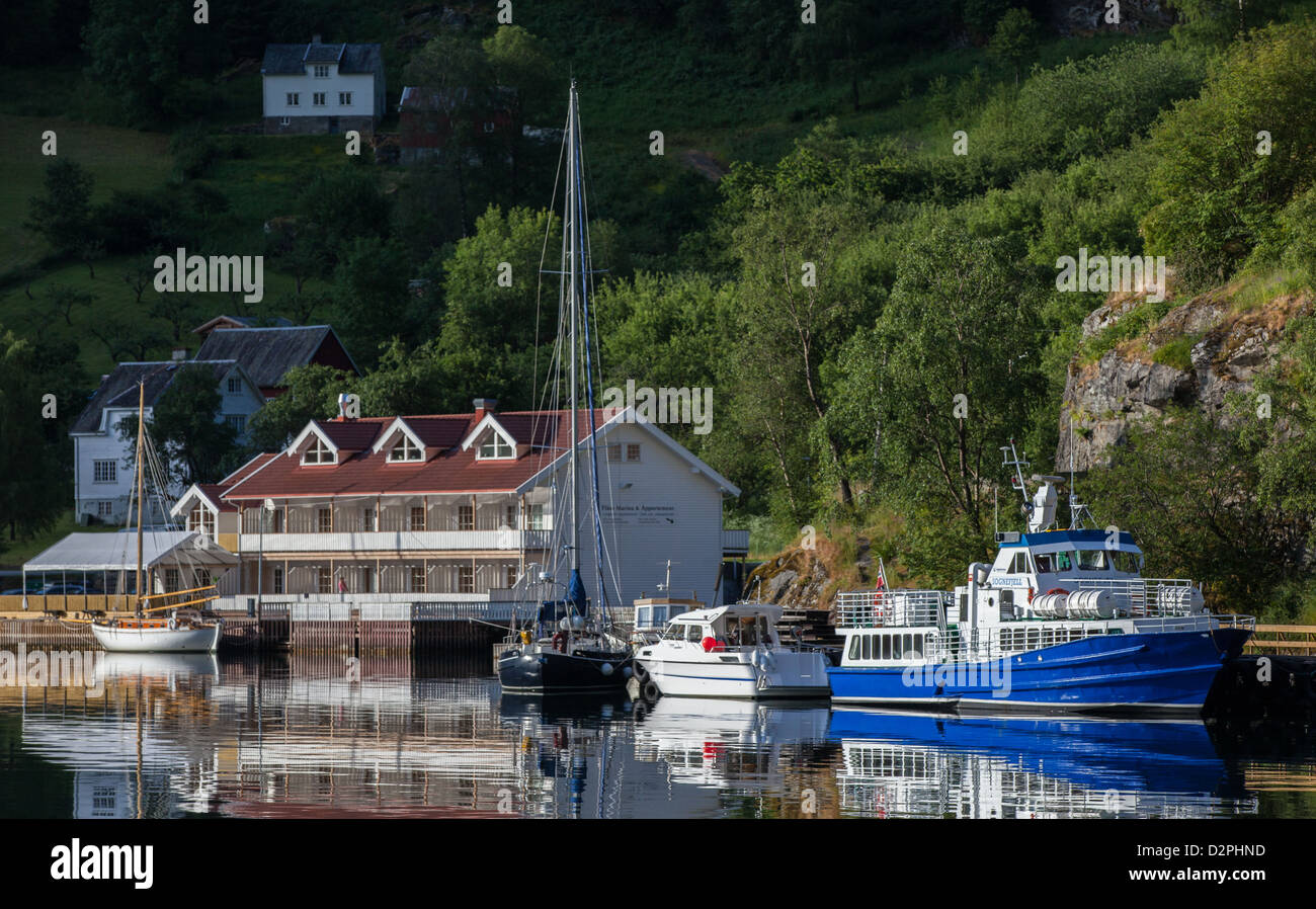 Hotel and boats on Aurlandsfjord in Flåm Norway, a village on the Sognefjord, the largest fjord in Norway. Stock Photo