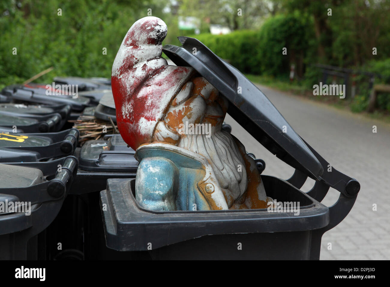 Berlin, Germany, garden gnome in a dumpster Stock Photo