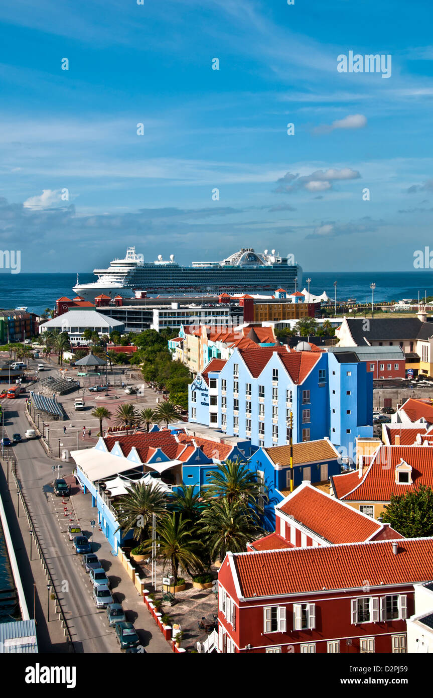 Above view of Otrobanda side of Willemstad, Curacao, showing bright Dutch colonial architecture and cruise ship at dock Stock Photo
