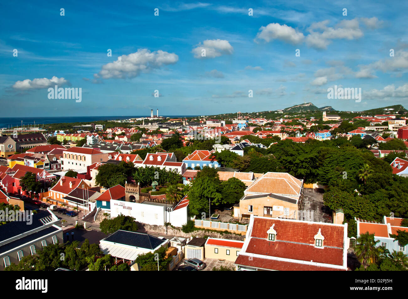 Aerial view above Otrobanda side of Willemstad, Curacao, showing colorfully painted Dutch architecture with red roofs. Stock Photo