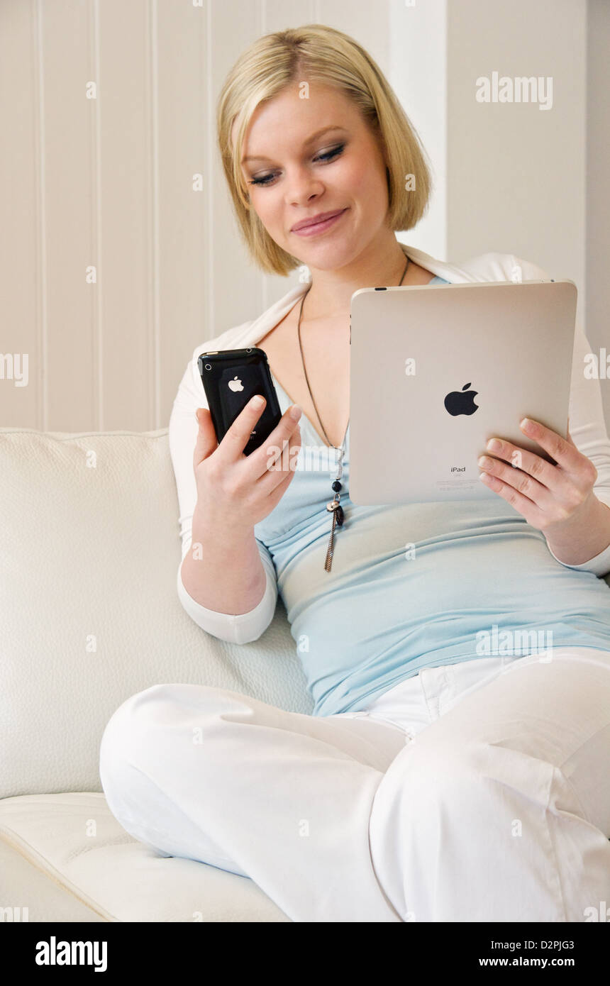 Hamburg, Germany, a young woman with the iPad and the iPhone 3G S Stock Photo
