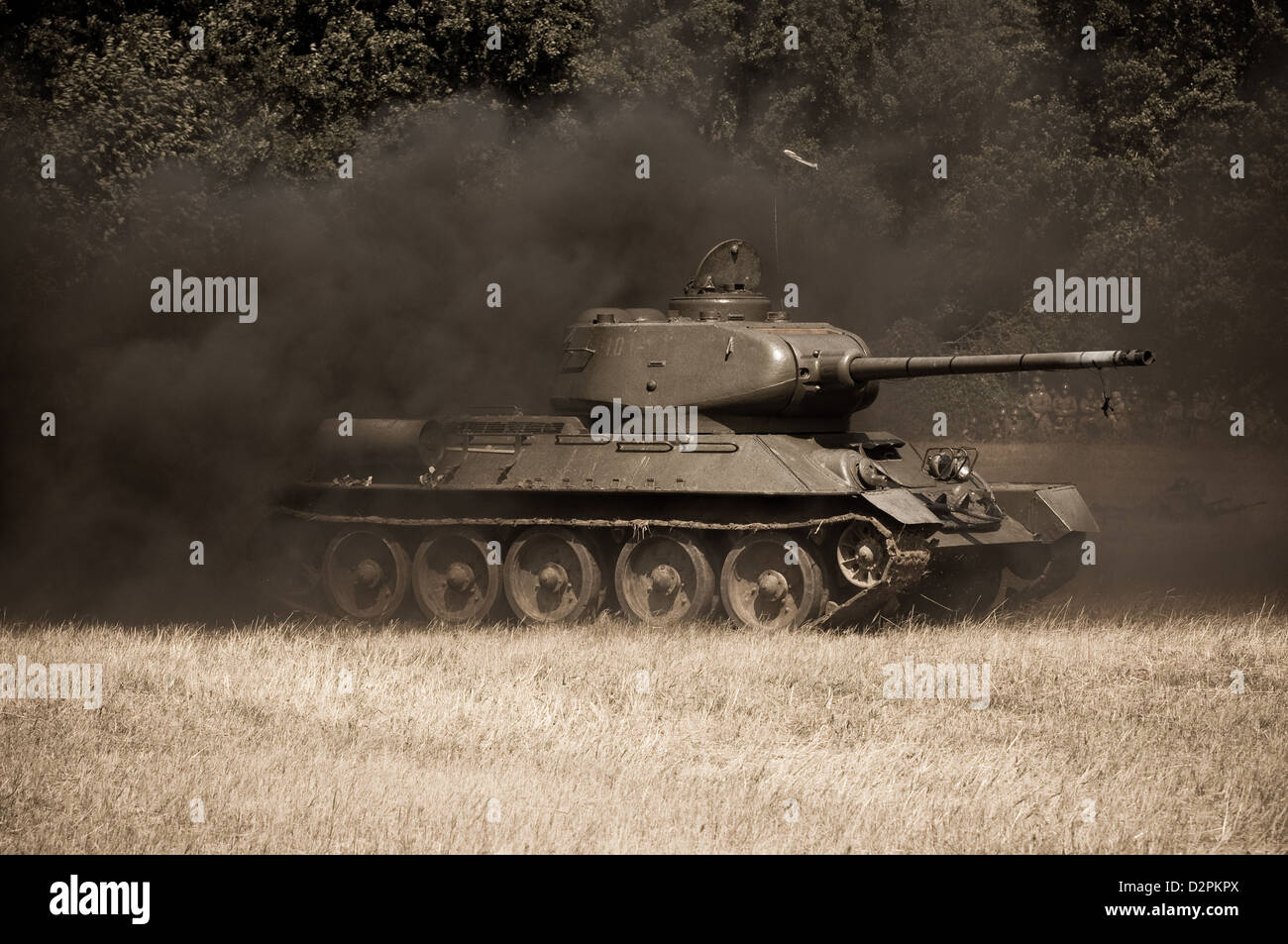 Damaged Soviet tank is covered with dark smoke - reenactment of World War II fights near river Hron on July 7, 2009 in Tekov SVK Stock Photo