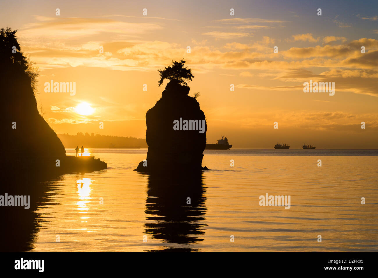 Siwash Rock, and Stanley Park seawall at sunset, Vancouver, British Columbia, Canada Stock Photo