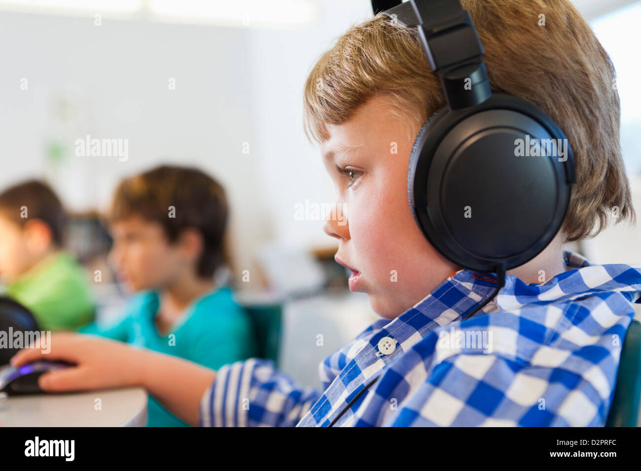 Caucasian student listening to headphones in classroom Stock Photo Alamy