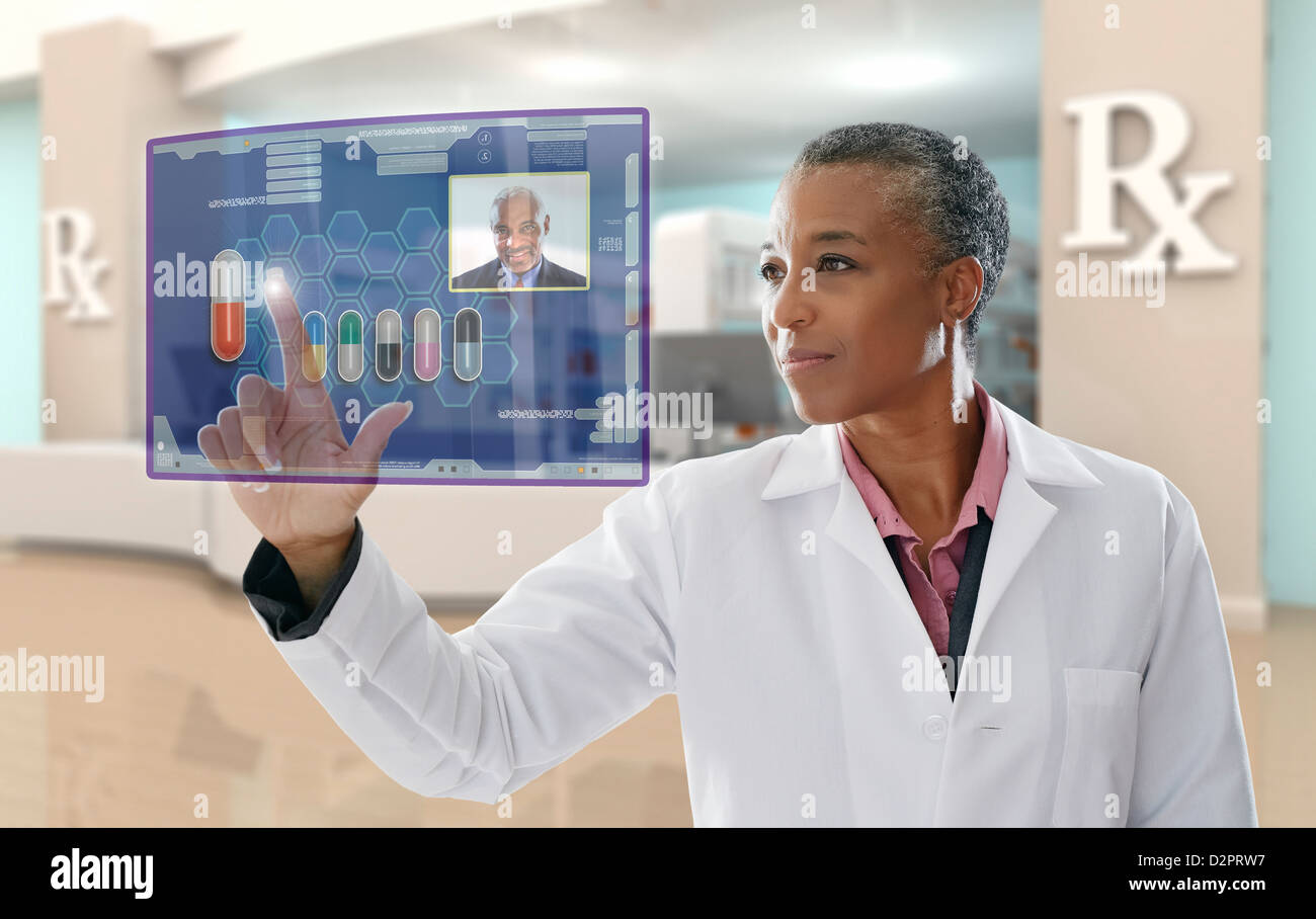 Black doctor using digital display in pharmacy Stock Photo