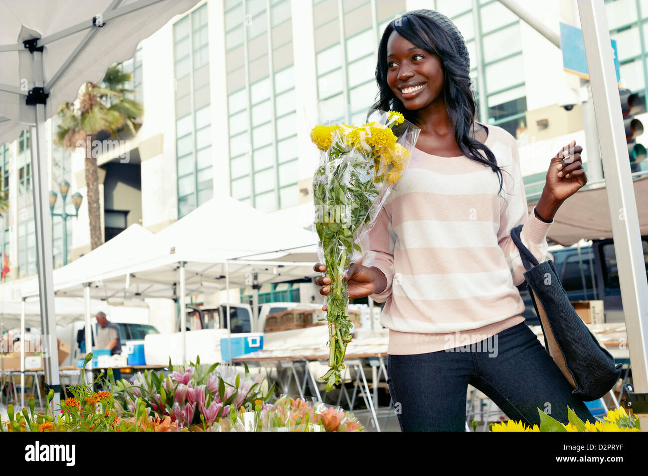 African American woman buying flowers Stock Photo - Alamy