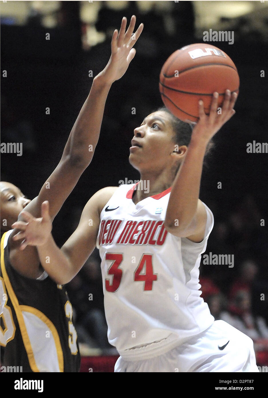 Jan. 30, 2013 - Albuquerque, NM, U.S. - UNM's #34 Whitney Johnson  drives to the hoop for the shot against Wyoming's # 33 Chaundra Sewell Wednesday evening in the Pit.Wednesday, Jan, 30, 2013. (Credit Image: © Jim Thompson/Albuquerque Journal/ZUMAPRESS.com) Stock Photo