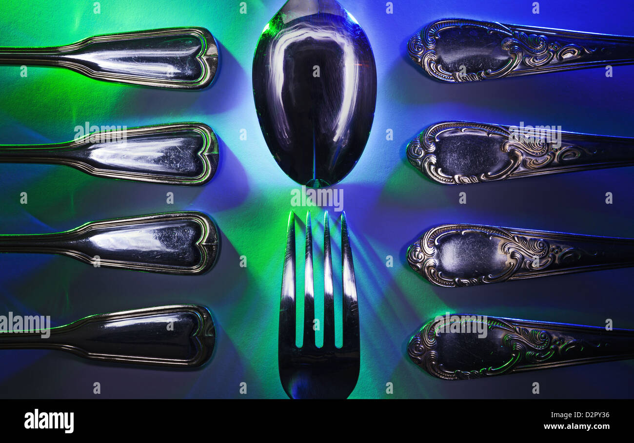 Details of forks and spoons on colorful background. Stock Photo