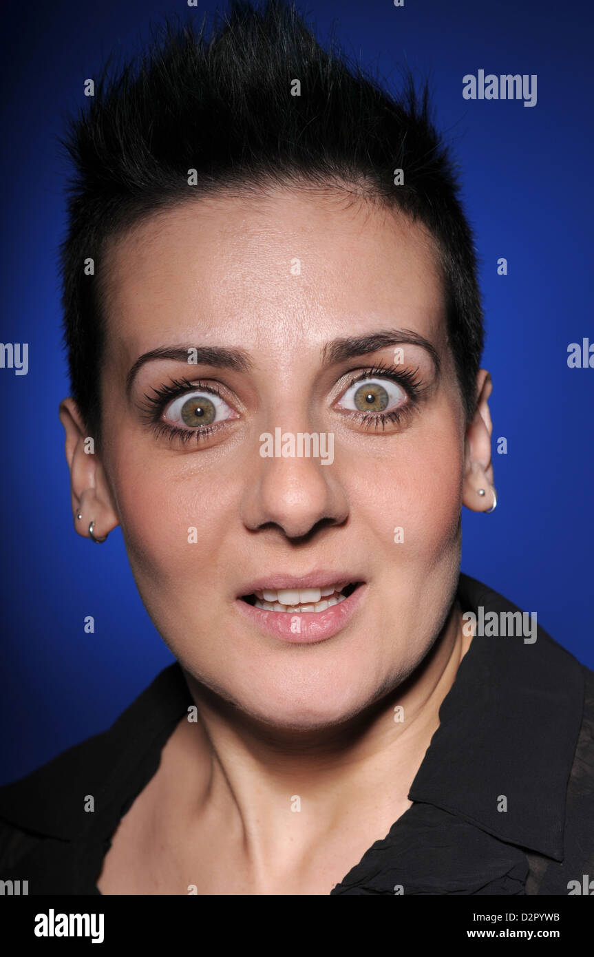 A young brunette woman makes facial expression Stock Photo