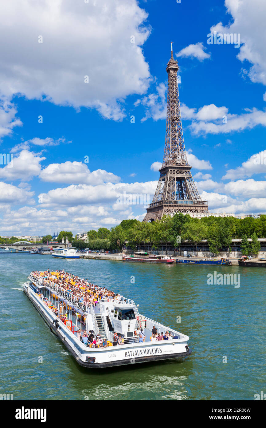 Bateaux Mouches tour boat on River Seine passing the Eiffel Tower, Paris, France, Europe Stock Photo