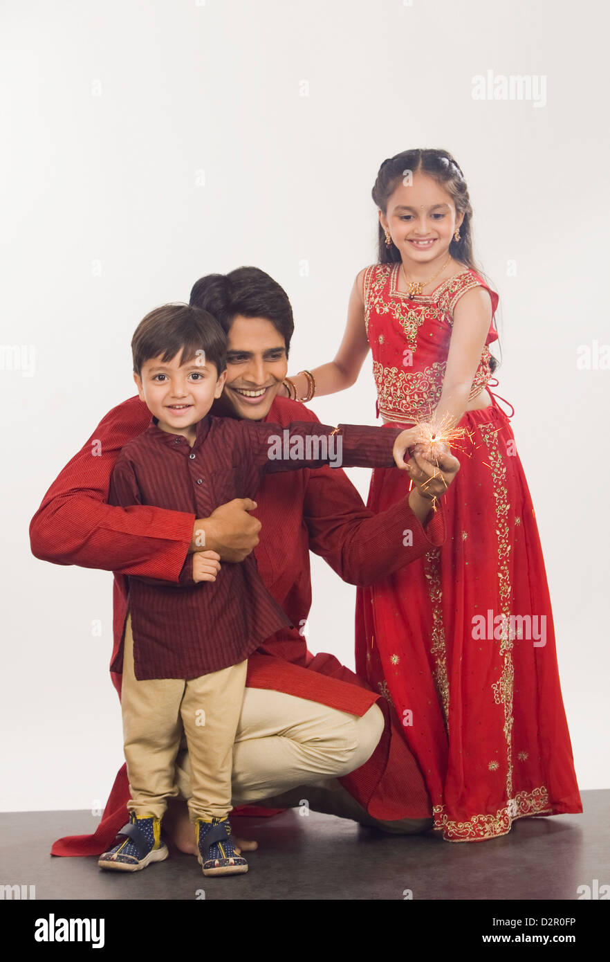Father and children celebrating Diwali Stock Photo