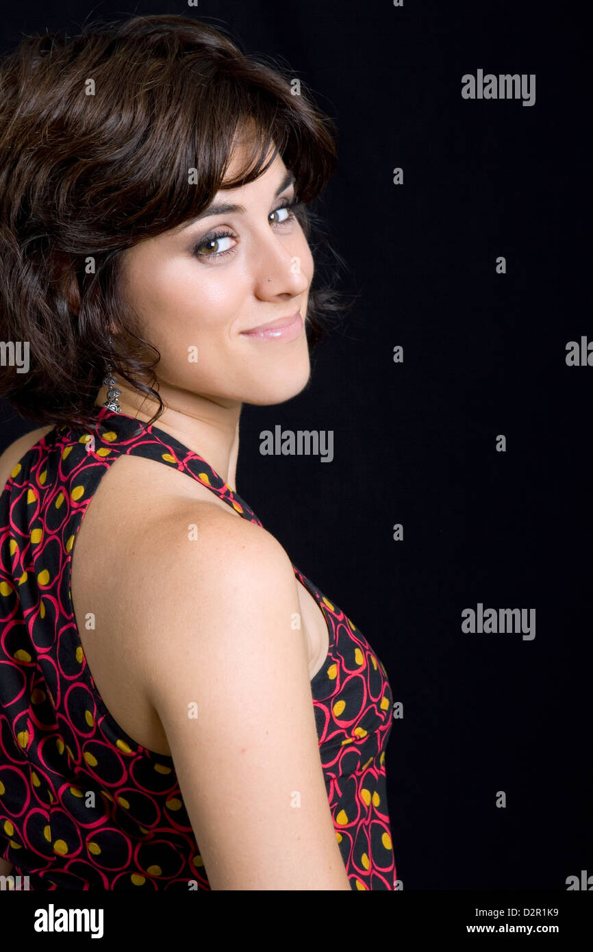 young beautiful brunette portrait against black background Stock Photo ...