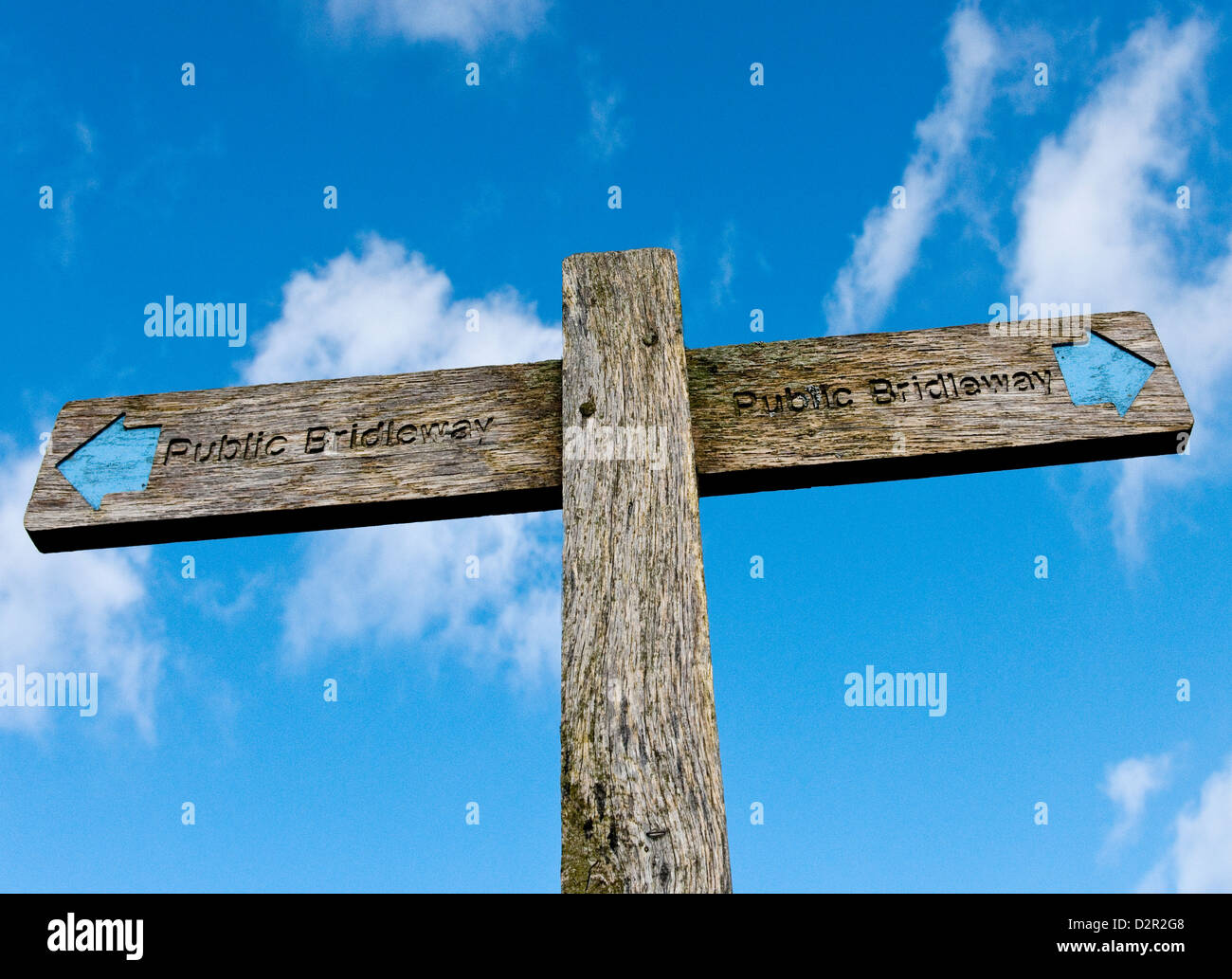 Signpost on the South Downs showing the direction of a Public Bridleway with blue sky and white clouds in the background Stock Photo