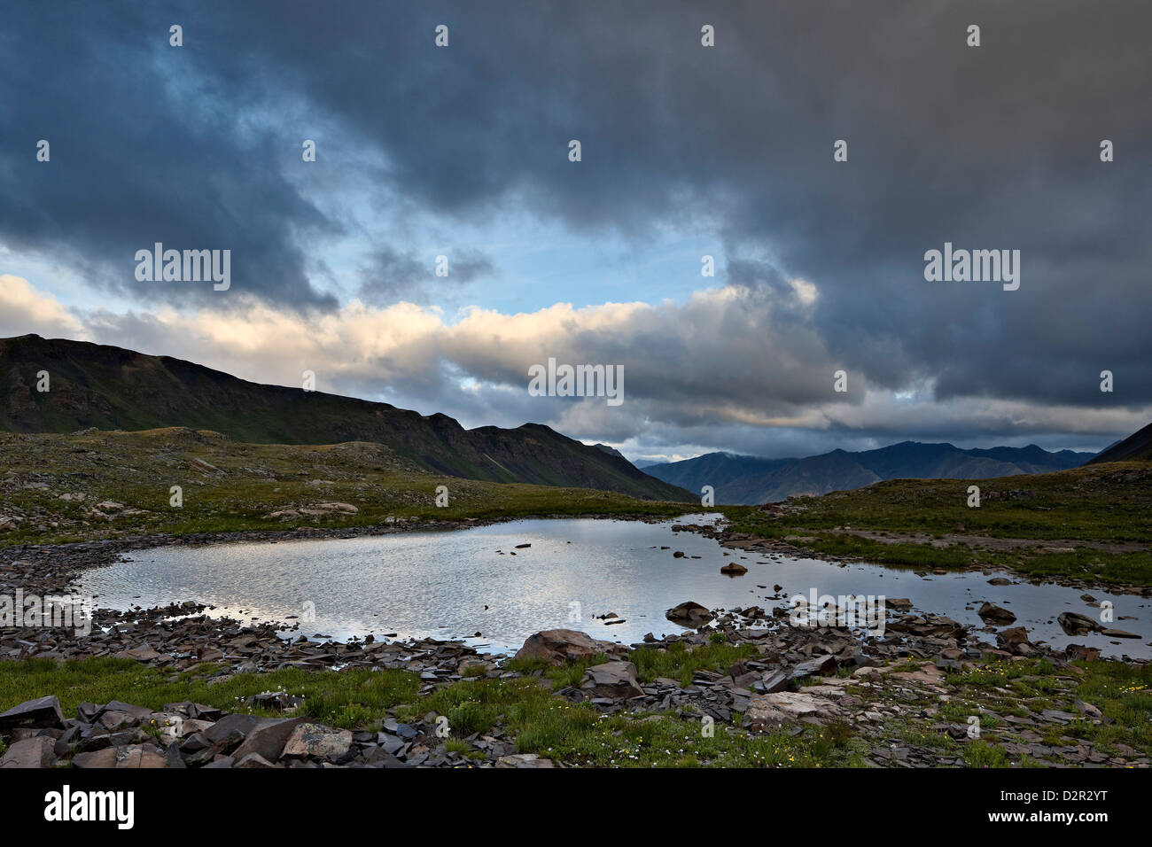 Cloudy sky above an Alpine tarn, San Juan National Forest, Colorado, United States of America, North America Stock Photo
