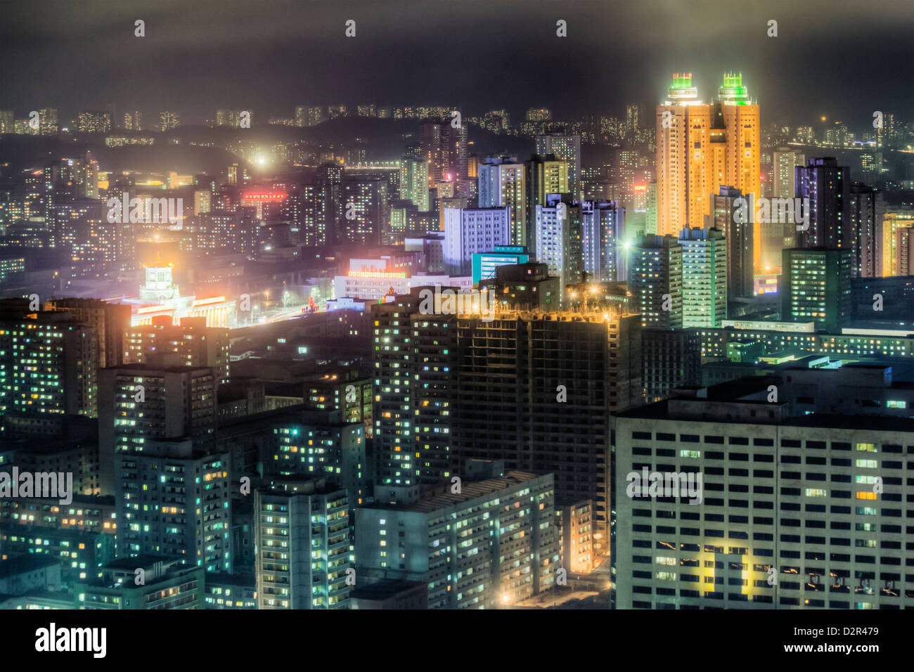 New modern buildings in the centre of Pyongyang colourfully illuminated at night, Pyongyang, North Korea Stock Photo