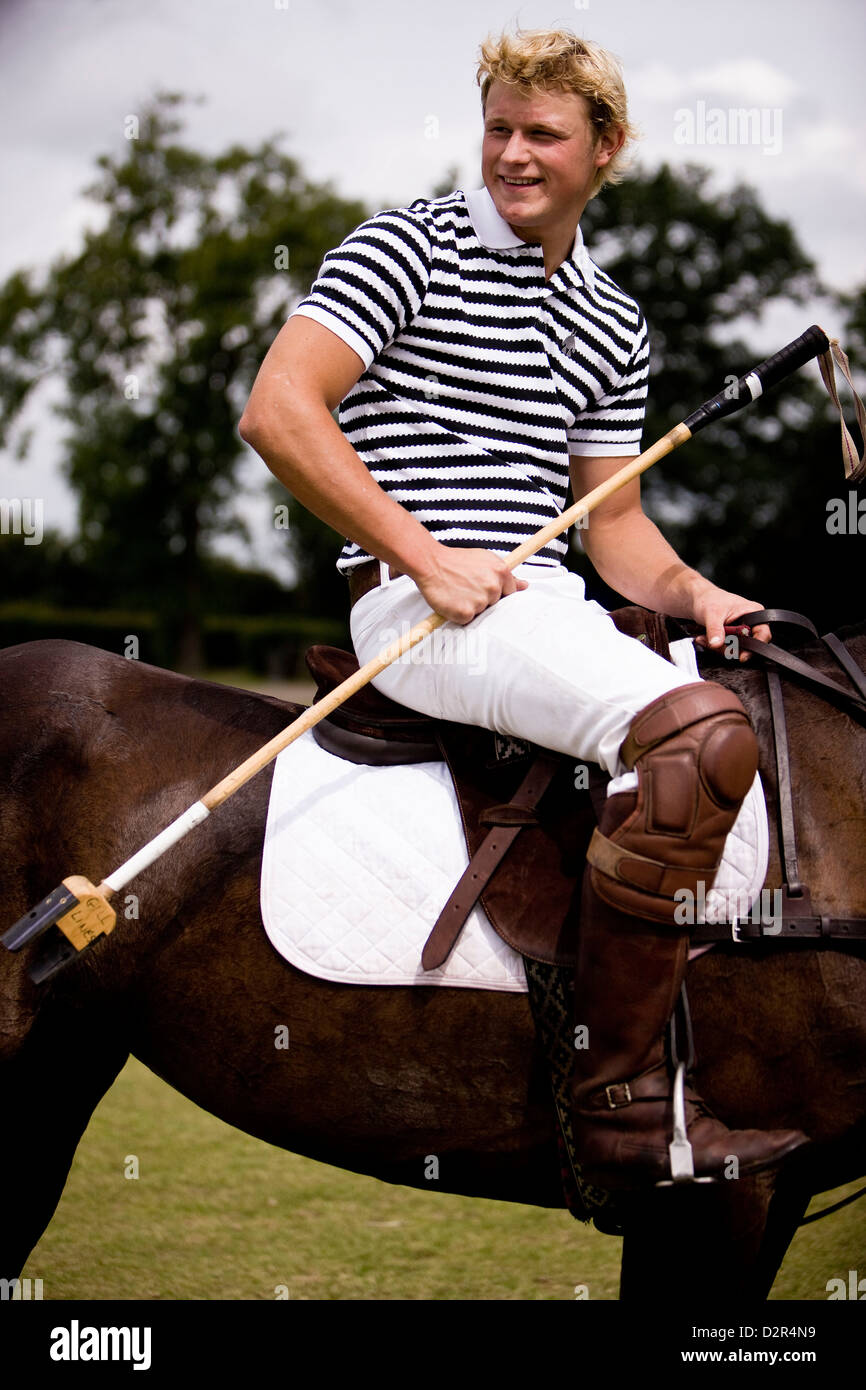 Portrait of polo player on pony holding reins Stock Photo