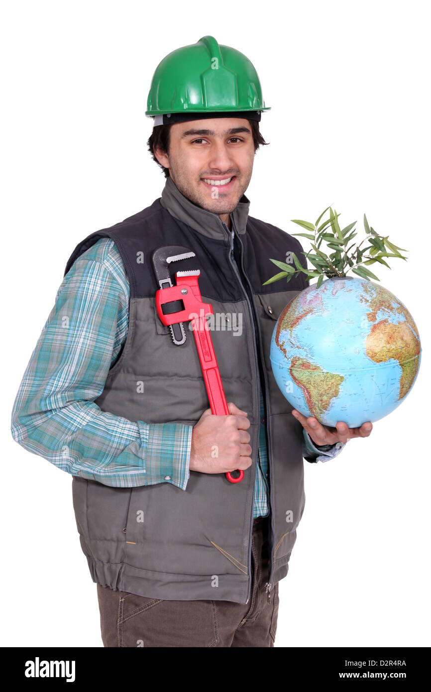portrait of manual worker holding globe and spanner Stock Photo Alamy