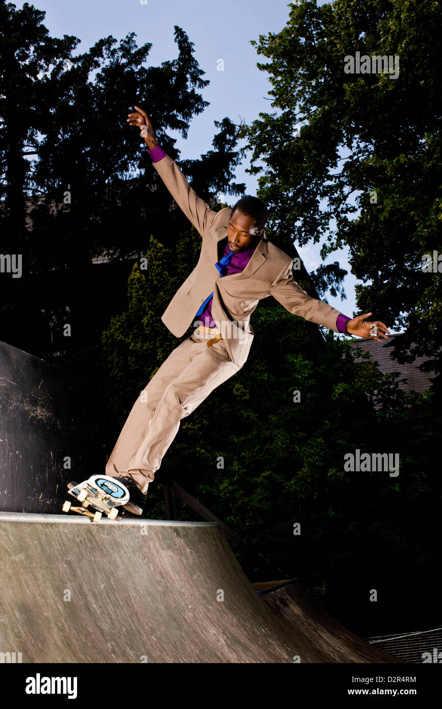 Skateboarding balance in full suit, London Stock Photo