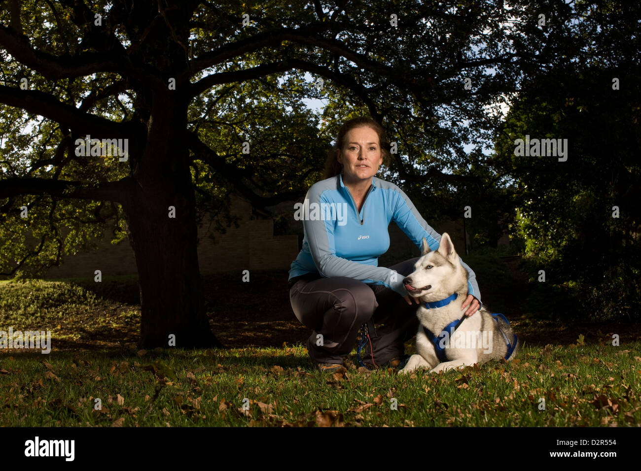 Woman with husky dog in park portrait Stock Photo