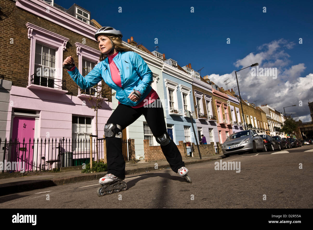 Woman rollerblading in urban street, primrose Hill, London Stock Photo