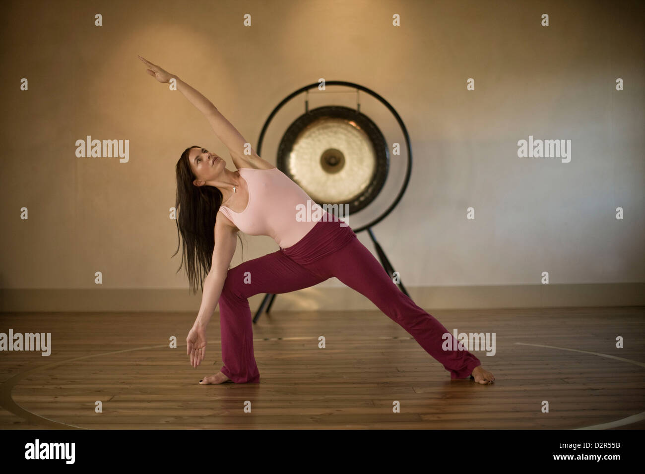 Woman demonstrating yoga position, triangle posture Stock Photo