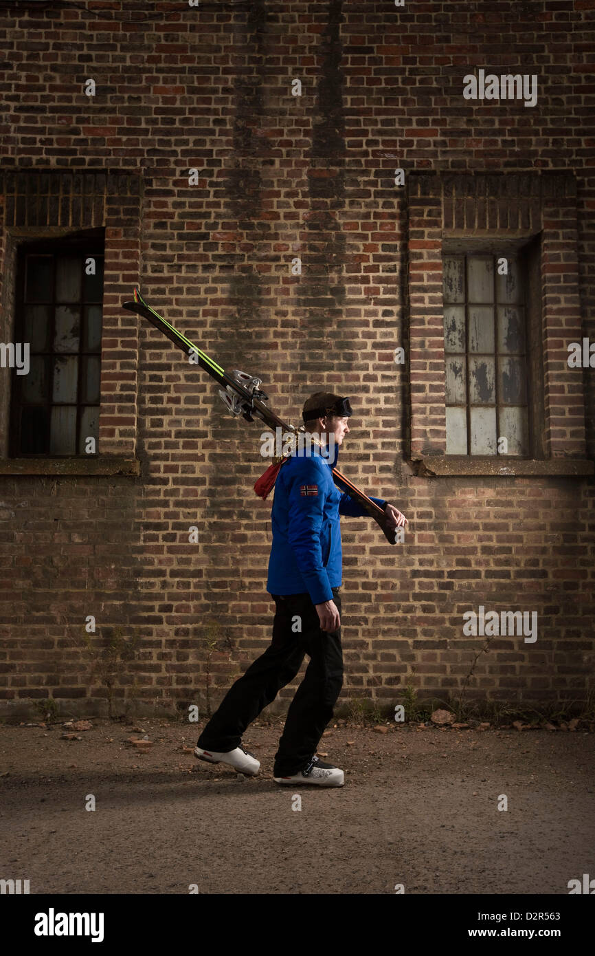 Man walking with skis in urban London, out of context Stock Photo
