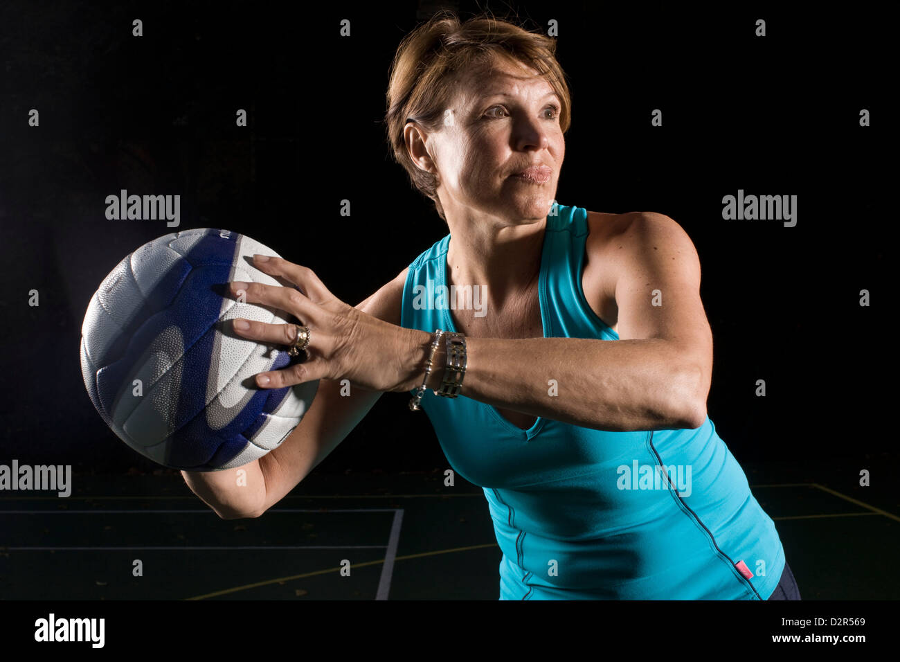 Netball player holding ball anticipating throw Stock Photo