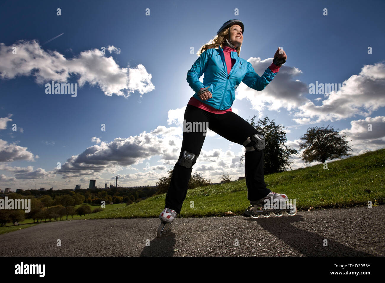 Woman rollerblading uphill, Primrose hill, London Stock Photo