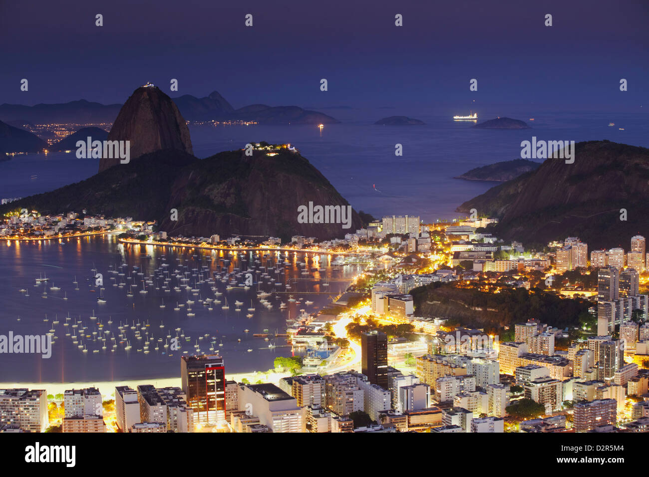 View of Sugar Loaf Mountain (Pao de Acucar) and Botafogo Bay at dusk, Rio de Janeiro, Brazil, South America Stock Photo