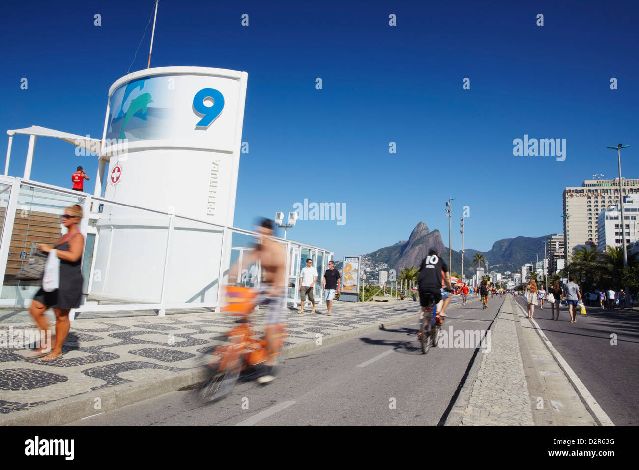 People cycling and walking along pedestrianised street on Sunday, Ipanema, Rio de Janeiro, Brazil, South America Stock Photo