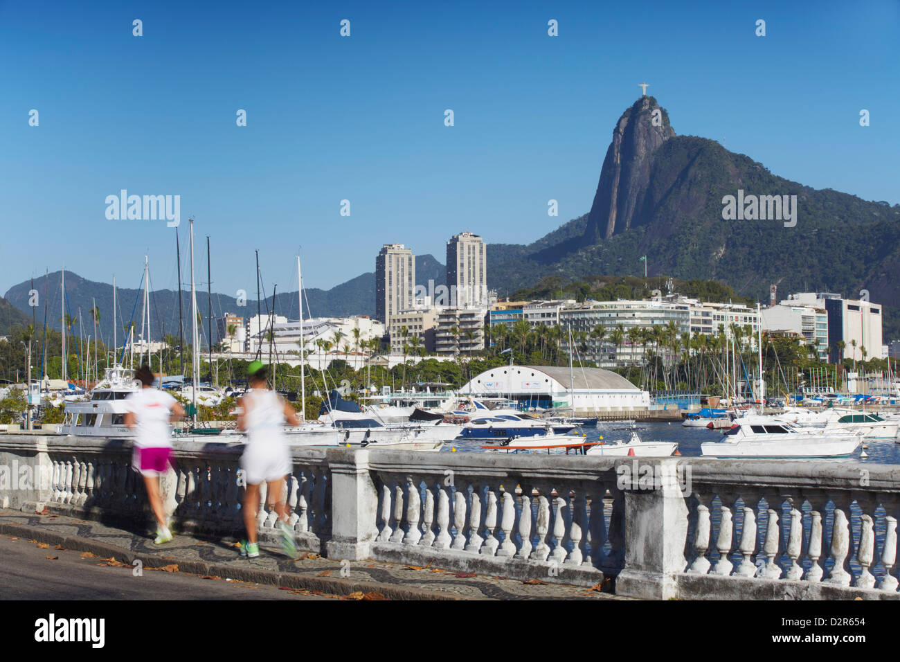 People jogging with Christ the Redeemer statue in background, Urca, Rio de Janeiro, Brazil, South America Stock Photo