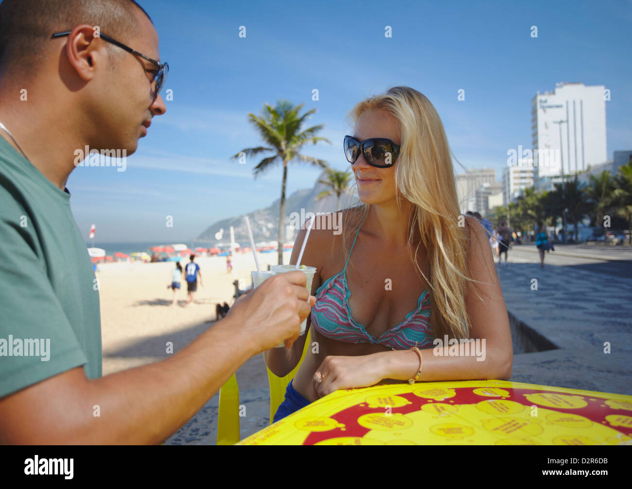 Couple with caipirinhas on Ipanema beach, Rio de Janeiro, Brazil, South America Stock Photo