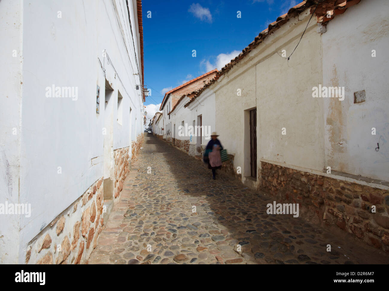 Woman walking along alleyway, Sucre, UNESCO World Heritage Site, Bolivia, South America Stock Photo