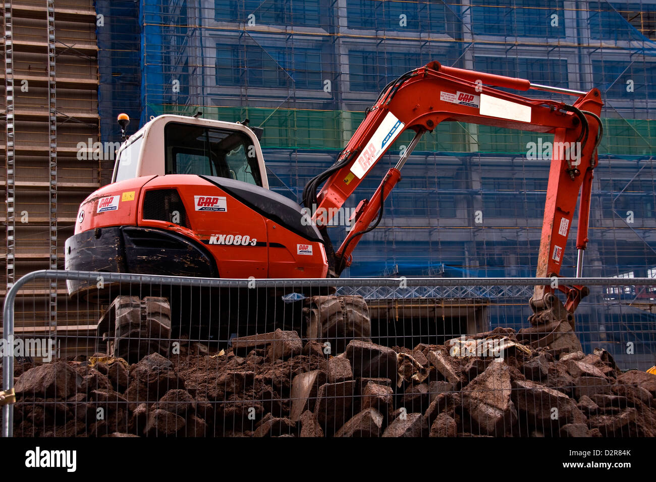An unmanned KX080-3 “Kubota Tractor” excavator sitting on top of a pile of rubble in Dundee,UK Stock Photo